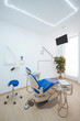 © Santi Miquel/ADDICTIVE STOCK - Spacious dental office with blue chair monitor tools and necessary for treatment