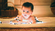 © Stockhunters/ADDICTIVE STOCK - Baby playing with light garland on Christmas Day