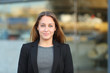 © Antonioguillem - Confident businesswoman posing looking at camera in the street