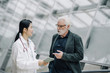 © Westend61 - Female doctor talking to senior man