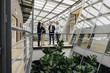 © Westend61 - Business people standing on a skywalk in modern office building