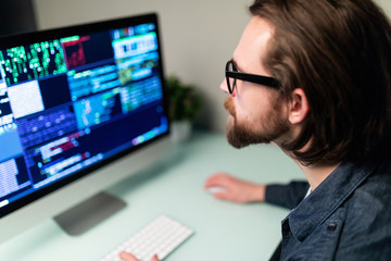 Software man developer on the computer screen and is analyzing the code.