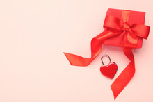 Gift Box With Ribbon And Padlock Shaped Heart On Pink Background