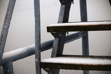Wooden Swimming Tower Steps With Metal Handrail Covered In Snow In Misty Light