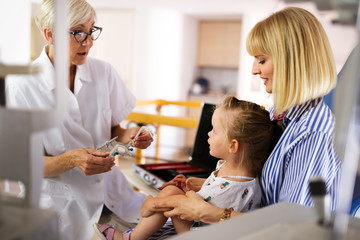 Wall Mural - Ophthalmologist, optometrist checking child vision looking for problems and caring for eye