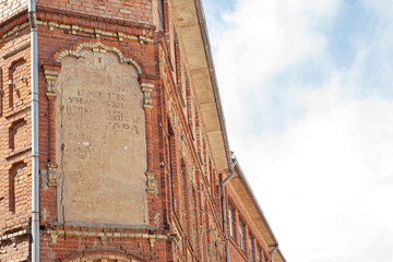 Wall Mural - Abandoned grunge cracked red brick building. Big stucco frame on the wall.