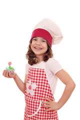 Wall Mural - happy little girl cook with sweet muffin