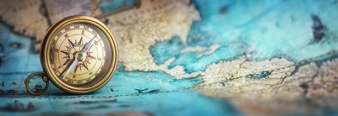 magnetic old compass on world map.travel, geography, navigation, tourism and exploration concept bac