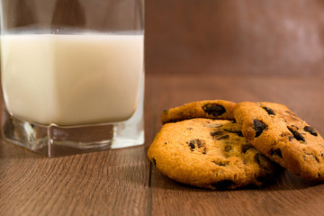 Biscuits with chocolate chips. Glass of fresh milk. Breakfast.