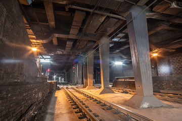  Big empty railway tunnel with many tracks near the underground railway station. Inside railway tunnel.