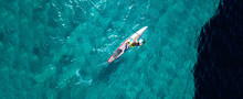 Aerial Drone Top Down Ultra Wide Photo Of Man Practising In Stand Up Paddle Or SUP Board In Tropical Exotic Sea
