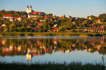 Poster - Tihany village and the Benedictian abbey in warm sunset colors with the inner lake in the front and a beautiful refletion on water at lake Balaton in Hungary