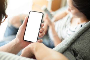 mockup image blank white screen cell phone.man hand holding texting using mobile.background empty sp
