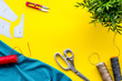 © 279photo - Sewing wokrshop. Textile, pattern, scissors, thread on yellow background top-down copy space