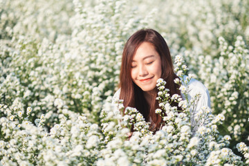 Wall Mural - Portrait image of an asian woman in a beautiful Cutter flower field