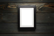 © Yeti Studio - Black frame hanging on the dark wooden wall