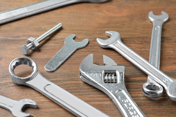 Auto mechanic's tools on wooden background, closeup