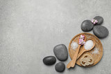 Fototapeta Mapy - Flat lay composition with sea salt and spa stones on grey marble table. Space for text