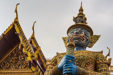 Giant statue is protect the darknest at Temple of Emerald Buddha (Wat Pra Kaew) in The Grand Palace Bangkok, Thailand.