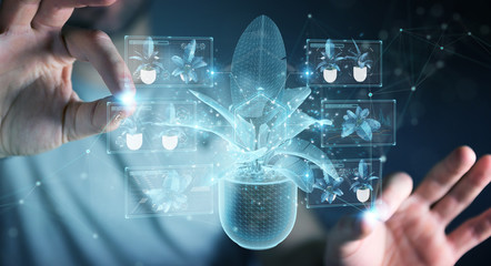 Fototapete - Man holding and touching holographic projection of a plant with digital analysis 3D rendering