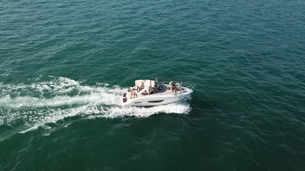 View of a private recreational boat with people sailing