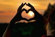 © Tunatura - Sillhouete of young woman making symbol of heart on the sky