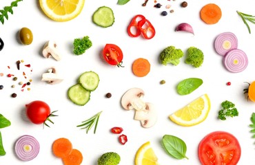 Food pattern with raw fresh ingredients of salad on white background. Creative layout made of vegetables,spices and herbs. Flat lay, top view. Food concept. 