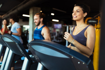 Wall Mural - Happy fit friends exercising, working out in gym to stay healthy together