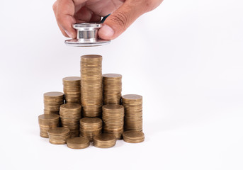 Stethoscope on coin stack, on white background. money for health care, Financial Aid, concept