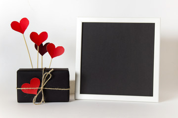 Empty blank frame with black paper and decorative heart love affection Valentine day elements.