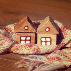 two houses wrapped in pink and white scarf together. joint insulation real estate heating