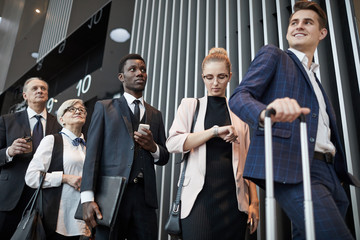 Wall Mural - Multiethnic group of people standing in the queue at the airport and registering before flight