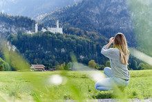 Tourist Taking Photos Of The Neuschwanstein Castle