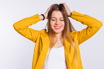 Wall Mural - young woman in a yellow jacket and a white blouse closed her eye