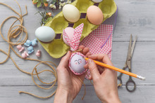 Woman Makes Cute Decorative Eggs For Easter Holiday. Do-it-yourself Easter Gifts Concept. Cute Pastel Colored Eggs