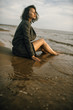 © Nikita - Woman portrait in  coat on sea beach