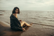 © Nikita - Woman portrait in  coat on sea beach
