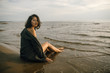 © Nikita - Woman portrait in  coat on sea beach