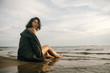 © Nikita - Woman portrait in  coat on sea beach
