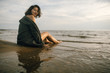 © Nikita - Woman portrait in  coat on sea beach