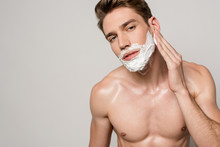 Sexy Man With Muscular Torso Applying Shaving Foam Isolated On Grey