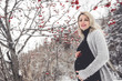 © Louis-Photo - Young happy pregnant woman in snowy forest