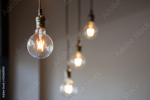 Cuadros en Lienzo vintage light bulb hanging from ceiling for decoration in living room