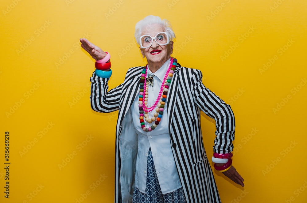 Funny grandmother portraits. Senior old woman dressing elegant for a special event. granny fashion model on colored backgrounds - obrazy, fototapety, plakaty 