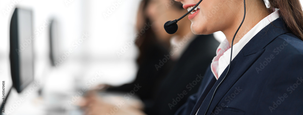 Beautiful businesswoman customer support services working with headset and computer at call center - obrazy, fototapety, plakaty 