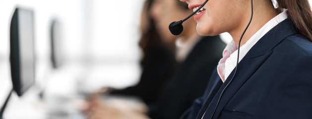 Beautiful businesswoman customer support services working with headset and computer at call center