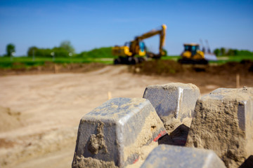 Close up view on spikes of road roller for compacting soil at construction site