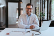 © bnenin - Portrait of a cheerful doctor in modern office.