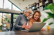 © bnenin - Portrait of a two women having fun and looking at laptop.