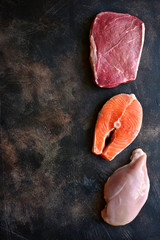 Poster - Raw marbled meat, red fish and chicken breast. Top view with copy space.